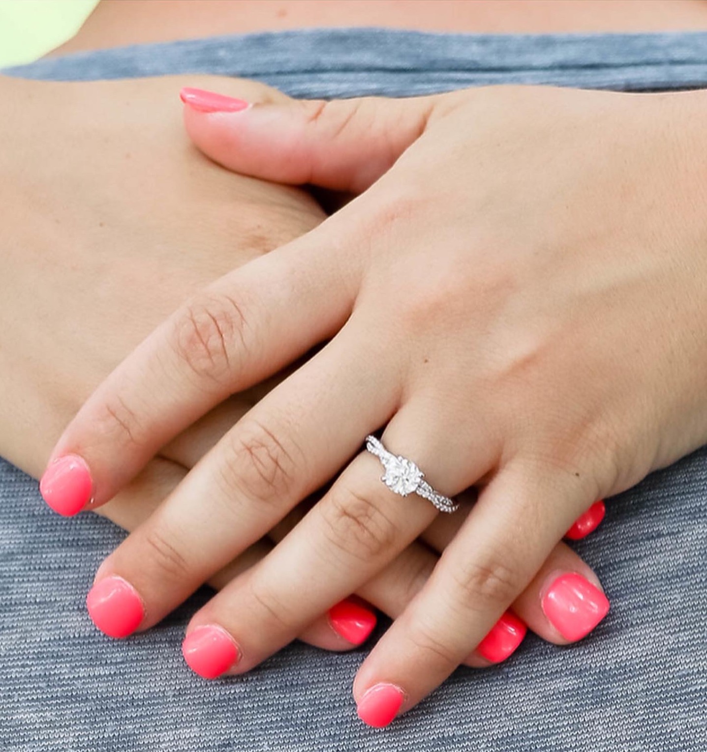 A person's hand with a ring on her finger
