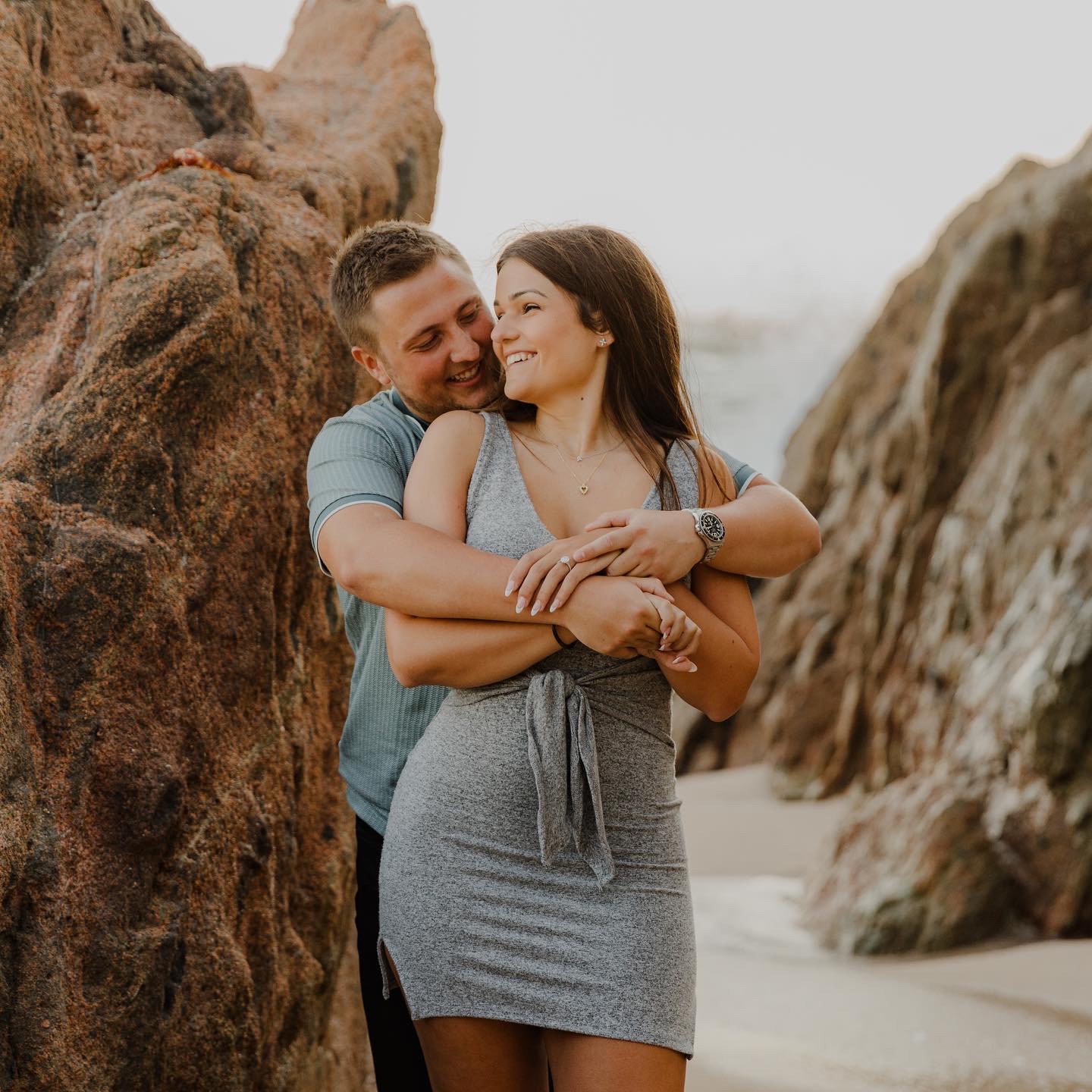 Ashley and Nicholas posing for picture on beach