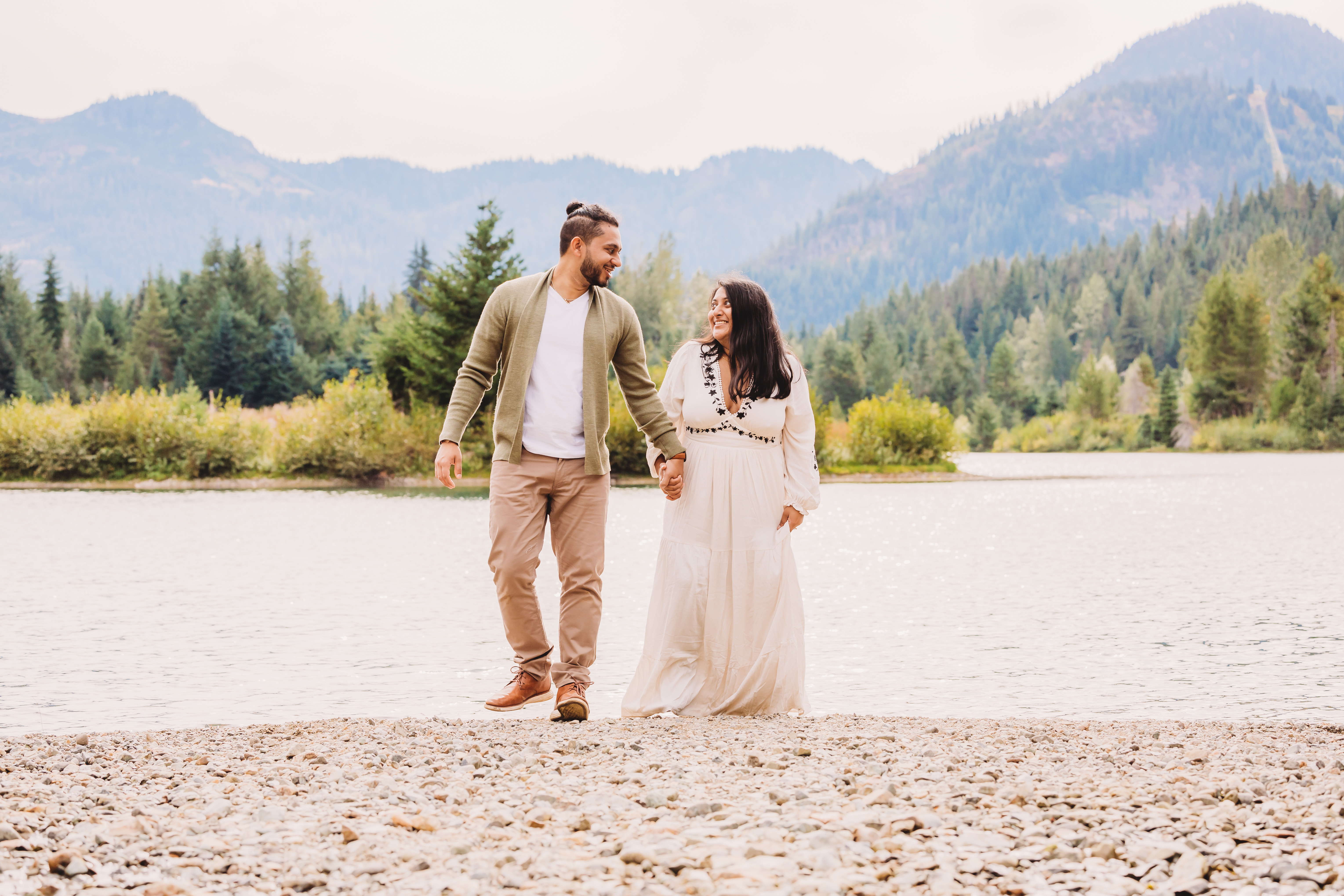 couple walking on a lake beach