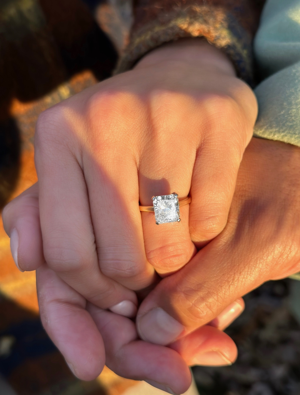 A Eric holding Razia hand and a small ring on his Razia hand.