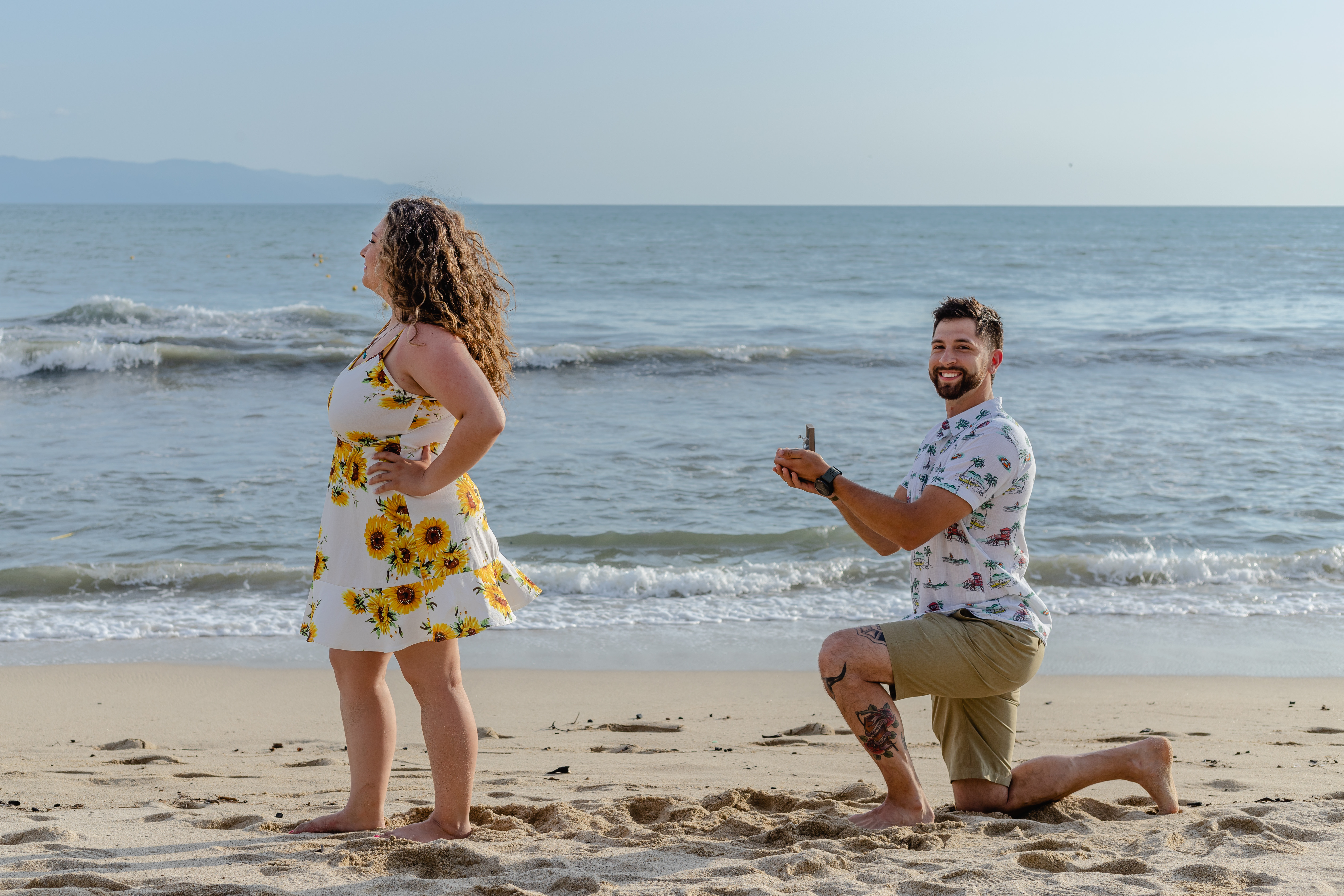 a person perposing a girl on the beach