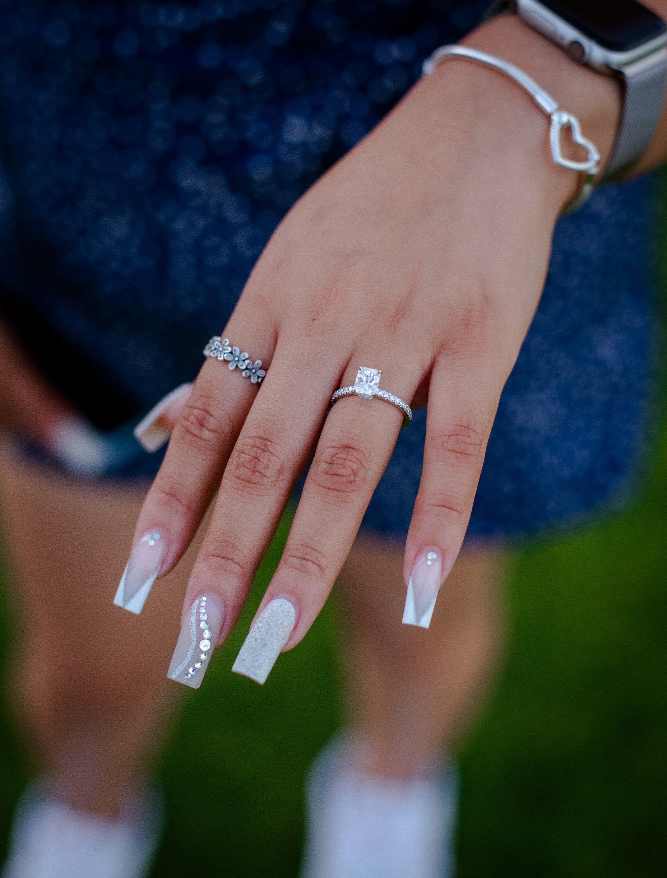 A close-up of a person's hands with wedding rings