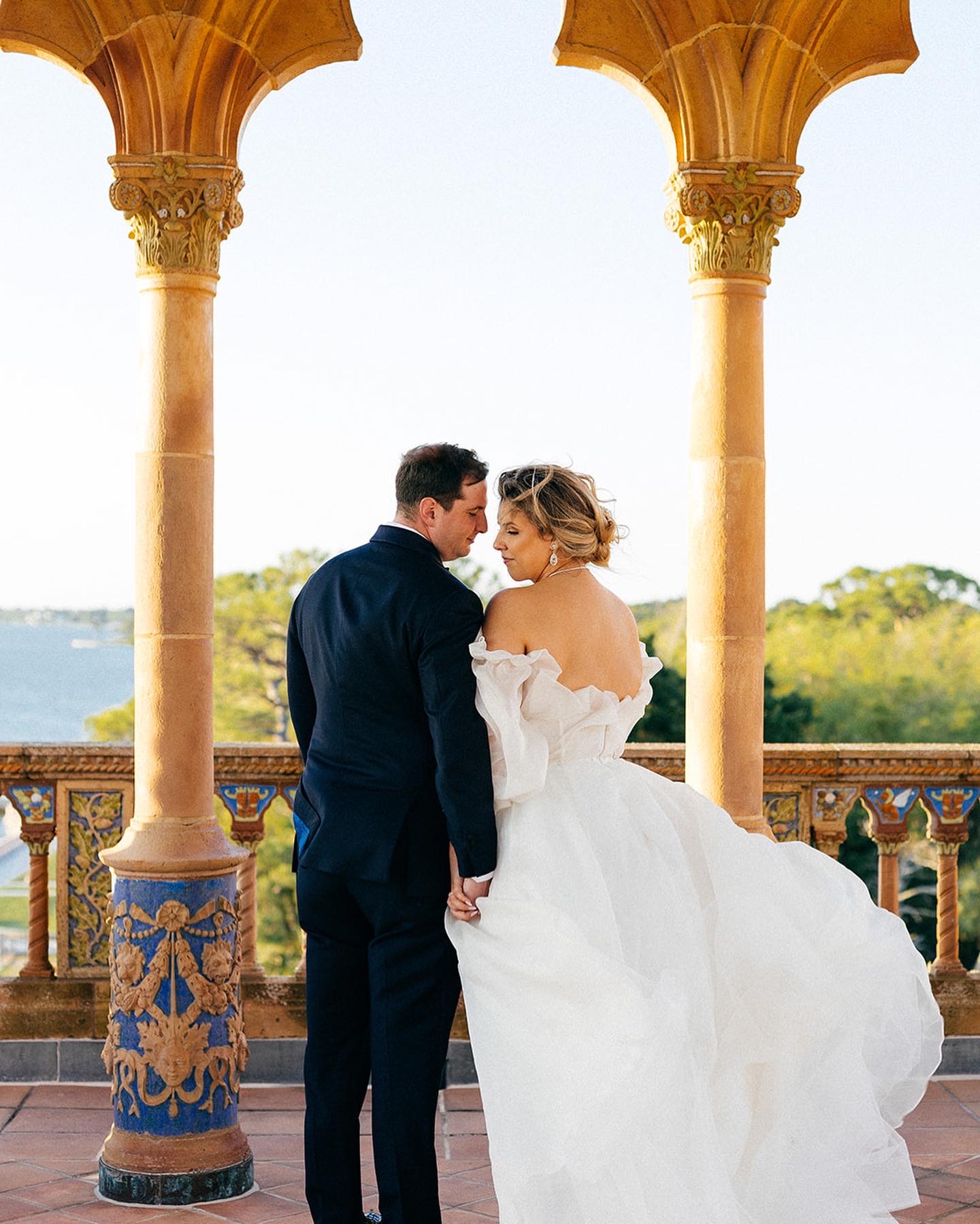 Sara and jordan standing in front of the balcony for a photoshoot