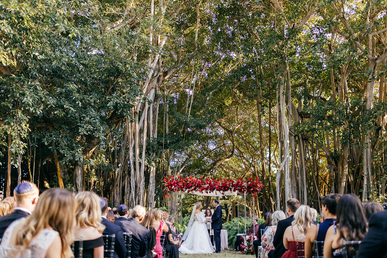 Sara and jordan standing in front of guests