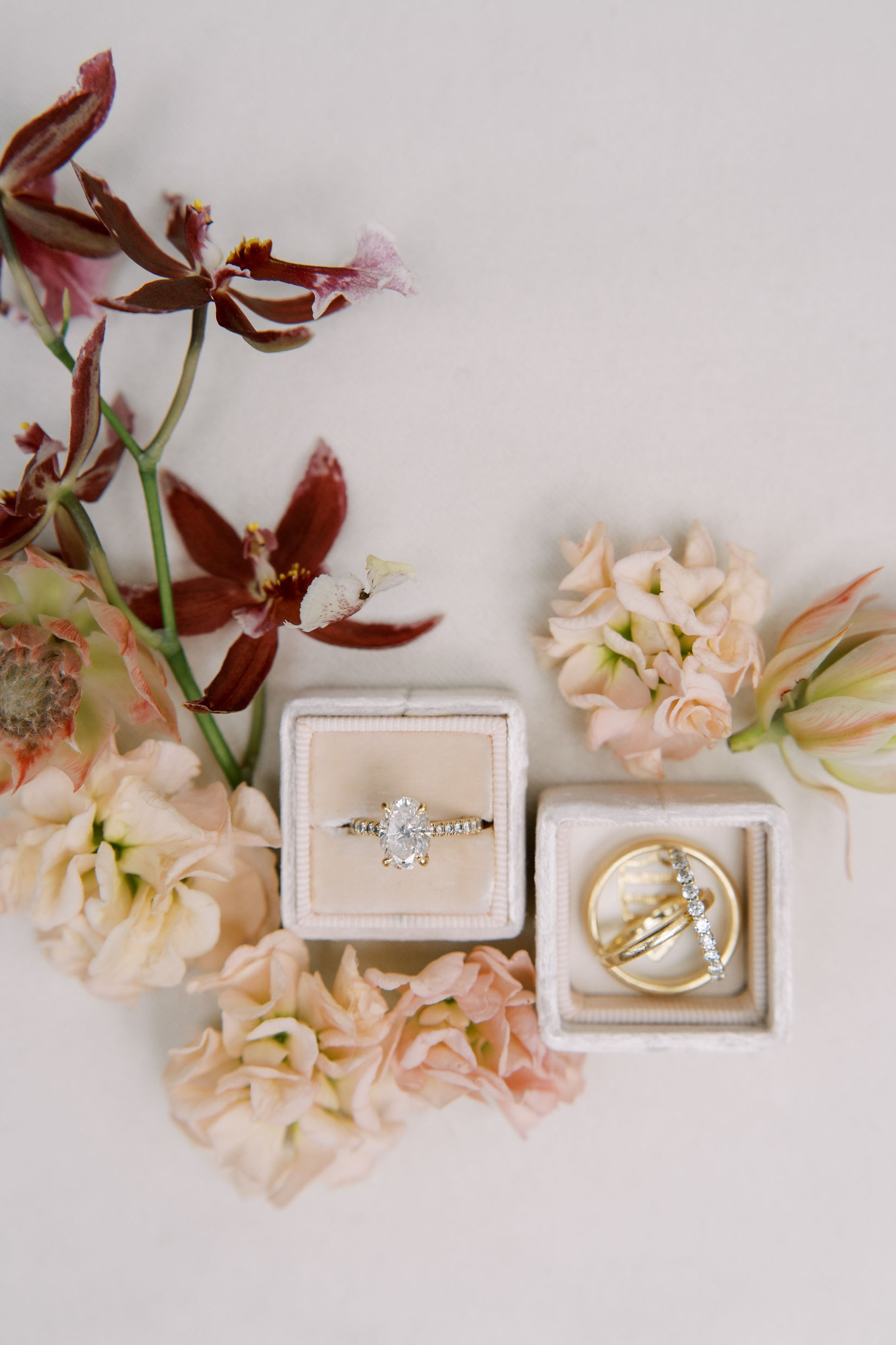 A group of flowers and two ring boxes