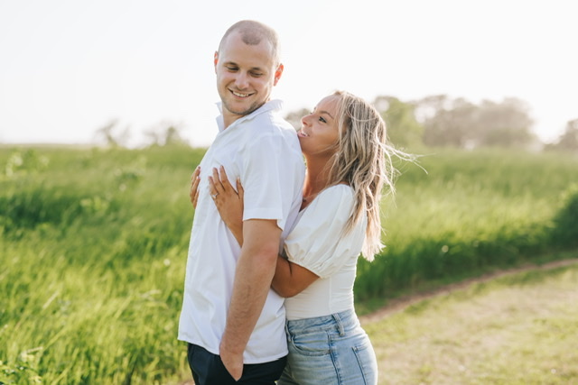 A couple hugging in a field